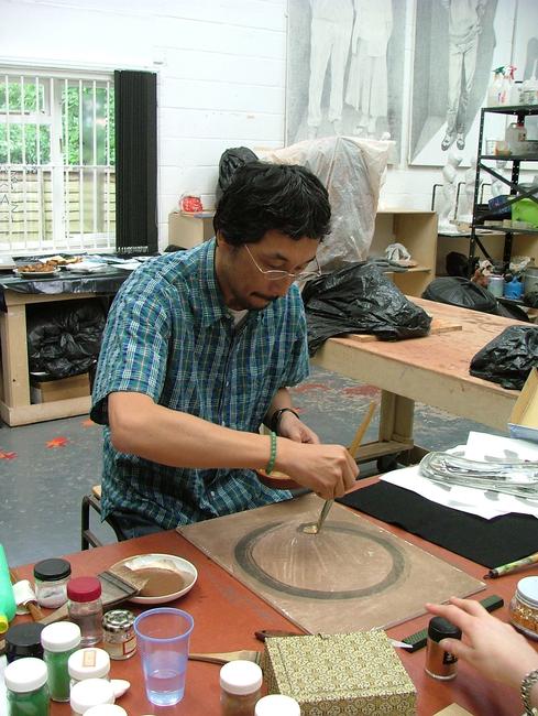 Image 1 - Artist Masashi demonstrating Japanese painting techniques during our open studio exhibition for the Artists and Makers Festival