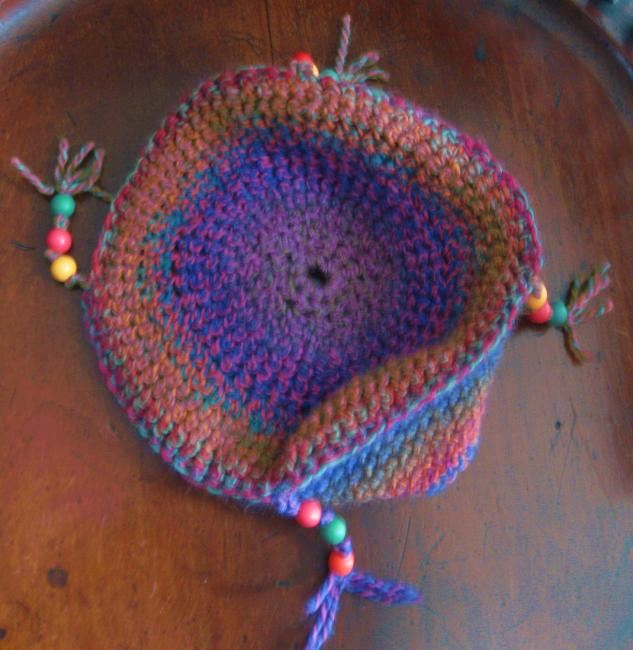 Round crocheted hat with wooden beads in wool and man-made fibre mix