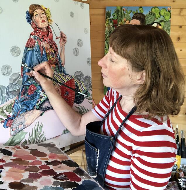 Lyn painting in her studio