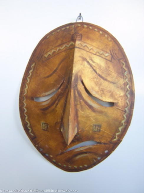 African sculpture style mask - sad face