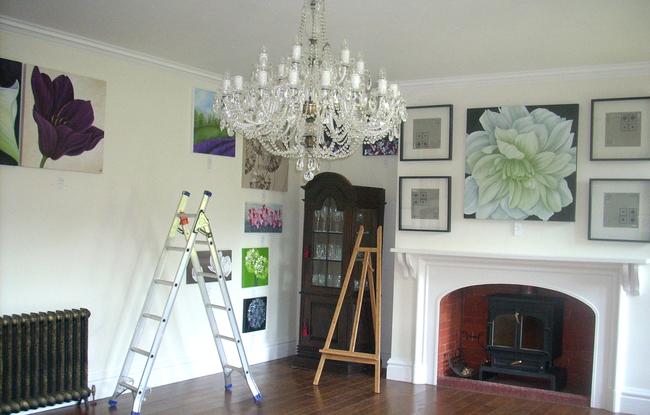 Hanging more paintings.
