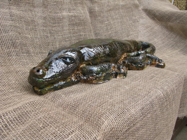 Clay sculpture of an alligator.