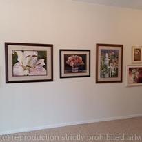 WALL OF ARTWORK IN GALLERY
