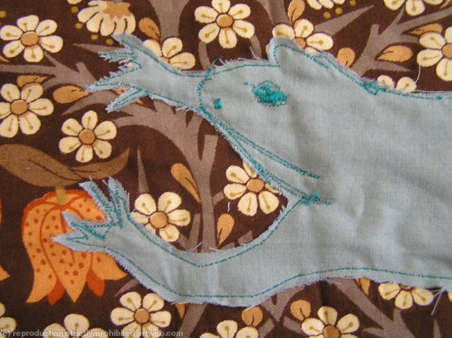 Detail of stitched drawing of frog from banner made for nursery school