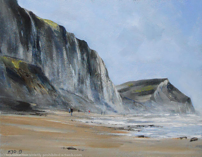 People on beach charmouth cliffs