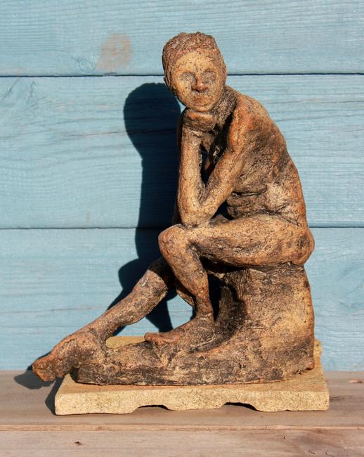 seated figure leaning forward