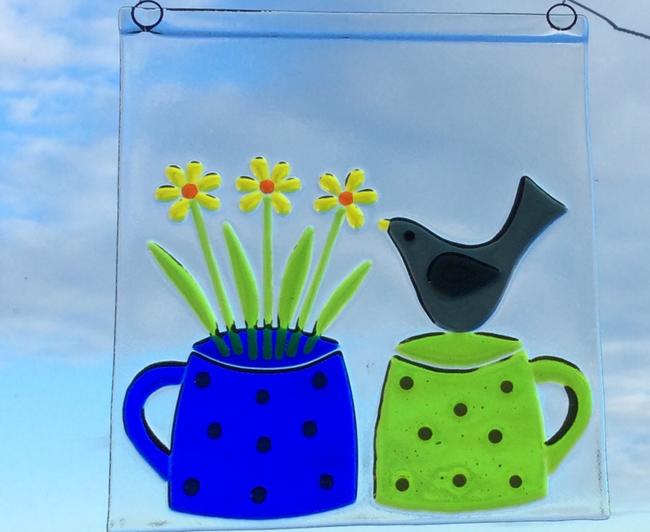 Blackbird and cups with flowers