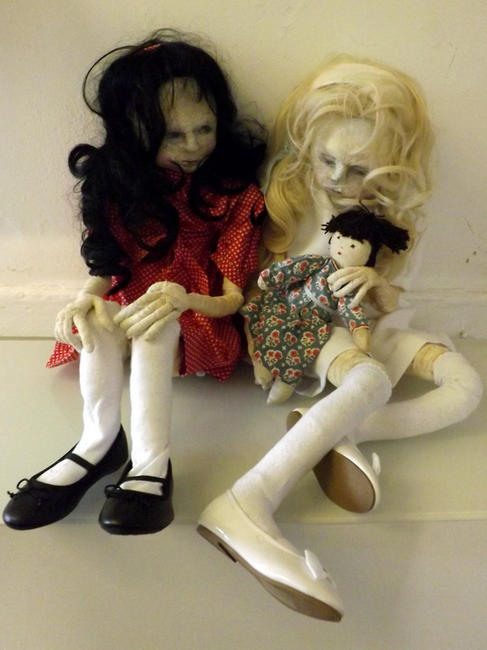 Two Little Girls Playing With A Doll