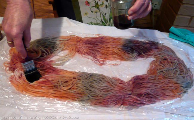 close up of hand painting wool yarn