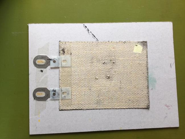 underside of lino with plastic tags clipped to metal pins