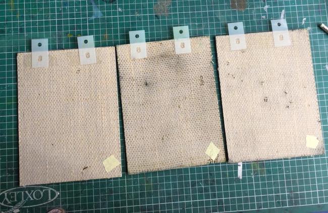 underside of all three linocut blocks with plastic tags secured in place