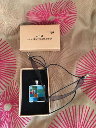 Medium sized silver tone with ribbon and thread