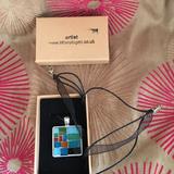 Medium sized silver tone with ribbon and thread