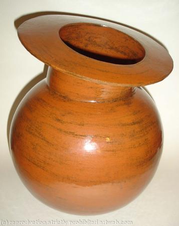 Stoneware pot with spherical body and tilted rim.