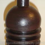 Black stoneware bottle with three ribs