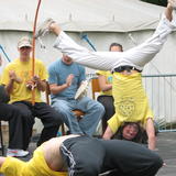 Capoeira Angola on the main stage - Laurie smiling and styling Vs Ben