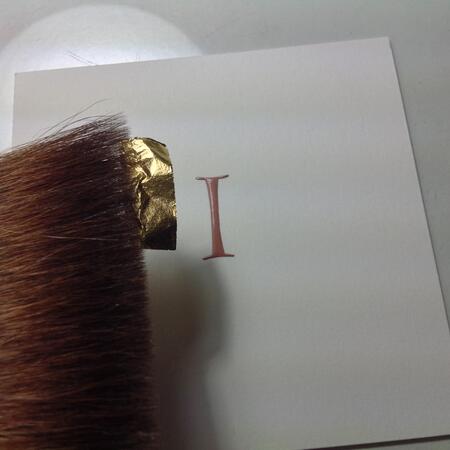 Applying gold leaf to gesso