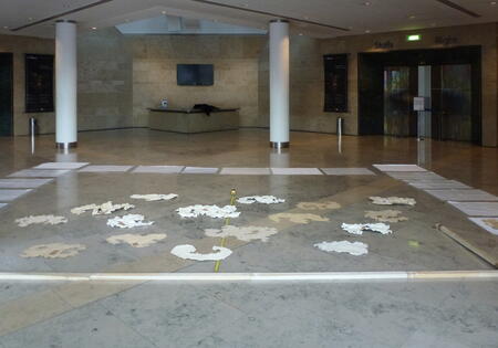 20 paper clouds arranged on the floor of Bridgewater Hall ready for installation