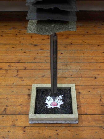 Sharp end of 4.5m  peat coring road suspended over the image of the birch pollen set in unbleached grass paper stained with peat water.