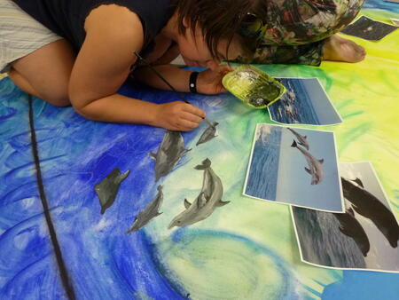 A scientist painting dolphins in her spare time.