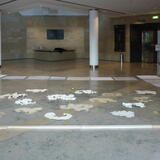 20 paper clouds arranged on the floor of Bridgewater Hall ready for installation