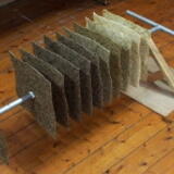 Assembly of paper squares on to peat coring rod prior to installation at Brantwood.