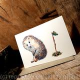 Hedgehog ( Skillipigs ) card No. 33 'Golf putting'. This is a 6 by 4 inch card with a recycled envelope. It can have HAPPY BIRTHDAY or HAPPY RETIREMENT etc. on it in stick writing.