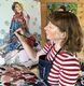 Lyn painting in her studio