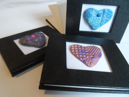 Concertina books - black bookcloth cover with cut outs and handmade embellishments