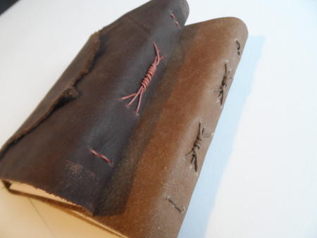 Leather covers waxed cord binding