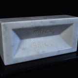 'Brick', Carved Carrara marble brick, life-size, on black granite base, individually numbered edition of 999, £500