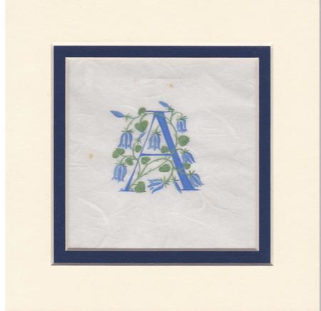 Initial A in dark blue with bluebells