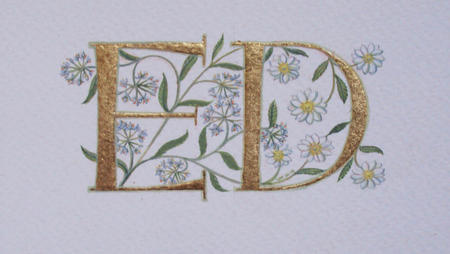 Two 23c gold leaf letters with wild garlic and mountain avens flowers.