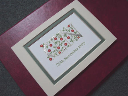 Two letters in Palladium leaf with red roses