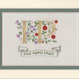 Two initials in 24c gold leaf with thistles, roses and musical notes