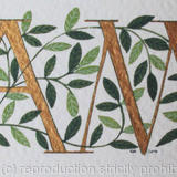 Two initials in gold with green leaves