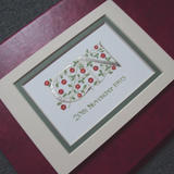 Two letters in Palladium leaf with red roses