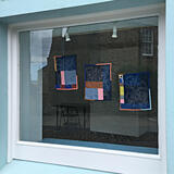 Window with wall hangings by Amy Blackwell