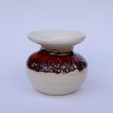 Tiny solar red and white glazed bottle