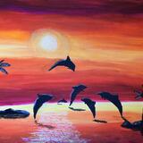 Dolphins jumping in the sunset 