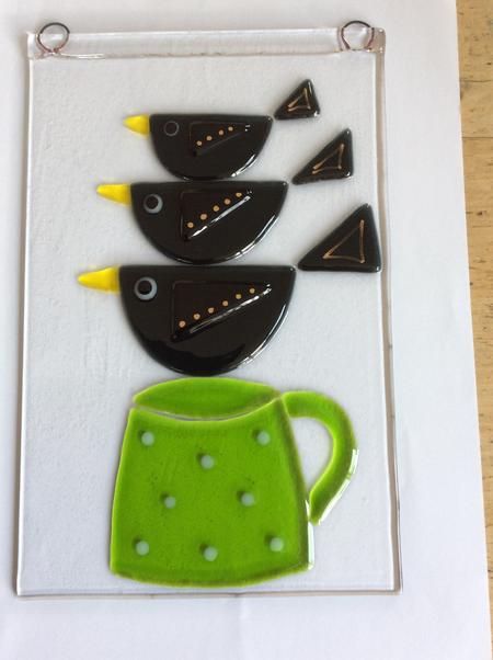 Trio of blackbirds on cup
