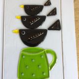 Trio of blackbirds on cup