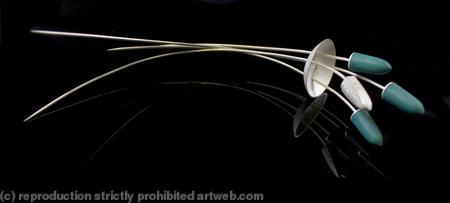 green and silver pin