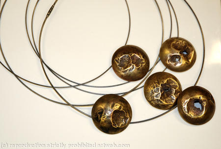 collection of earth from air brass domed pendants on oxidised silver cables